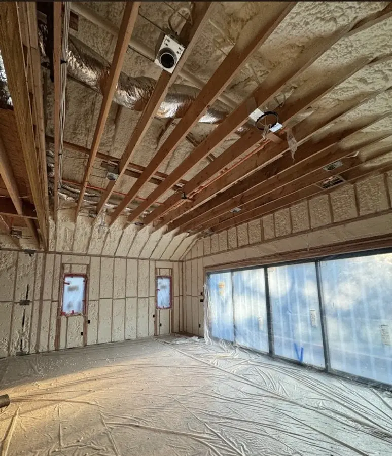 Interior walls and ceiling insulated with spray foam during new construction in Rogers